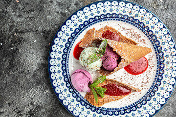 Tasty appetizing ice cream in waffle cones with mint on dark background. Top View