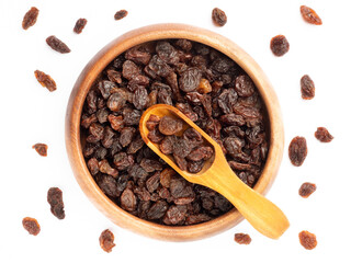 Raisin in wooden bowl and scoop, bunch isolated on white background with raisin. Macro. Healthy food concept