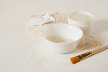 white bowls with rice and rice water, fermented skin and hair care products, organic cosmetics, light background