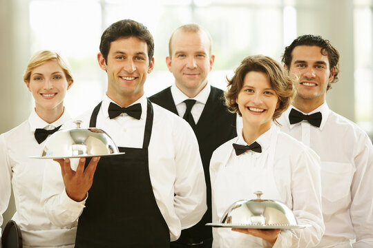 Group of waiters carrying trays