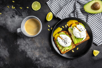Healthy Breakfast with Wholemeal Bread Toast and Poached Egg Sandwiches with avocado and poached egg. Healthy food, keto diet, diet lunch concept. Top view