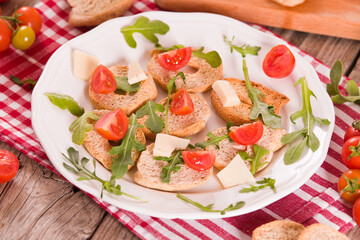 Friselle with cherry tomatoes and arugula.