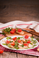 Friselle with cherry tomatoes and arugula.