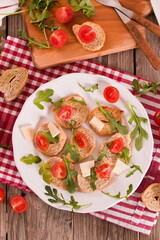 Friselle with cherry tomatoes and arugula.