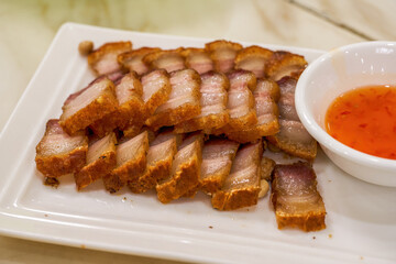 A crispy and delicious Chinese traditional Cantonese dish with crispy skin and pork belly