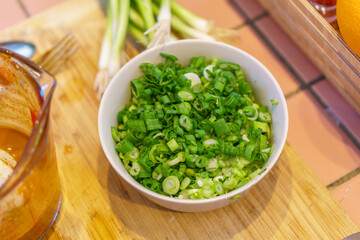 Close-up of food preparation with various asian ingredients and sauces.
