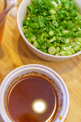 Close-up of food preparation with various asian ingredients and sauces.