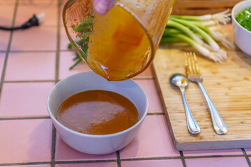 Close-up of food preparation with various asian ingredients and sauces.