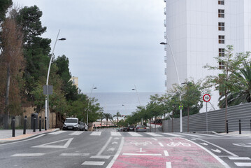 Fototapeta premium Bike lane on a downhill slope on an avenue in Benidorm, Spain, leading to the beach.