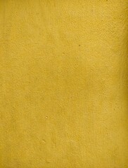 Texture cement wall painted yellow rough background, surface cement wall painted yellow for decoration.