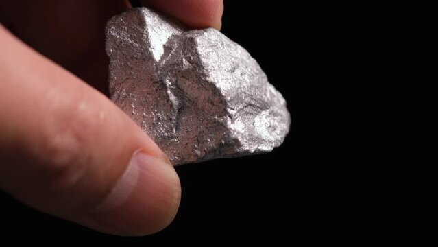 Miners hold in their hands platinum or silver or rare earth minerals found in the mine for inspection and consideration	