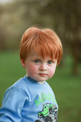 portrait of a little child with red hair