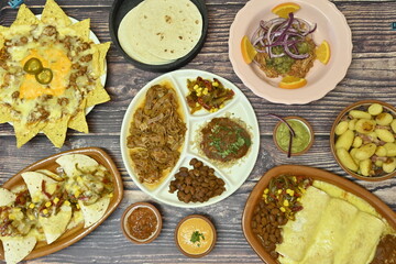 mexican food with fajitas, chili con carne and nachos with avocado, beef and cheese