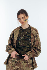 Girl in military uniform. Ukrainian. flag of Ukraine on the face. War in Ukraine. Bucha. on a white background