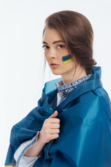A girl in Ukrainian vyshyvanka holds a flag. War in Ukraine. on a white background