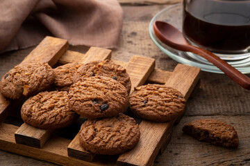 Fototapeta na wymiar Pile of Butter Chocolate chip cookies on wood plate