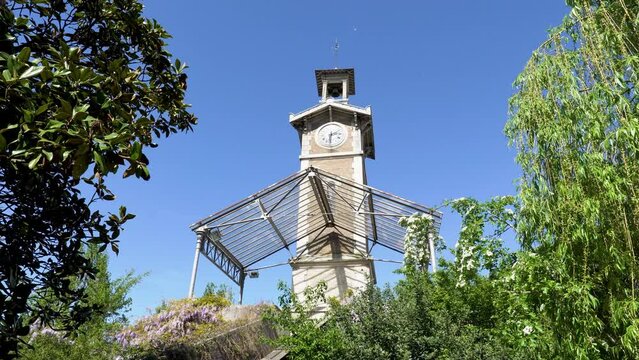 Static shot of Old Clock Tower of Georges Brassens Public Park located in the 15th arrondissement of Paris, France.