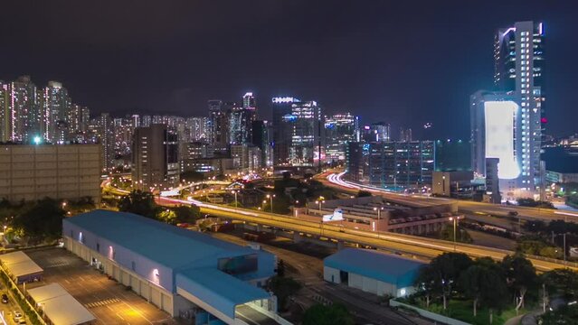Aerial view of busy traffic night in finance urban timelapse hyperlapse with panorama of city buildings, hong kong city