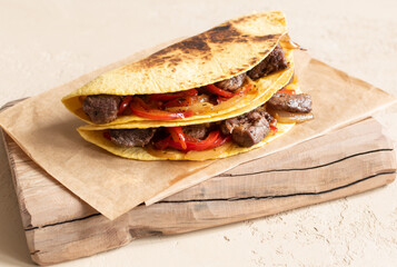 Mexican food. Quesadilla with beef, cheese, sweet pepper and green jalapeno