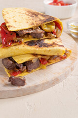 Mexican food. Quesadilla with beef, cheese, sweet pepper and green jalapeno