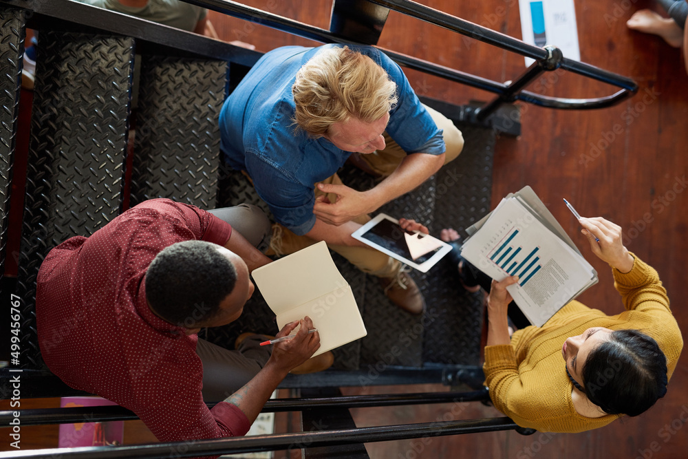 Poster Sales graph pointing downwards is a problem, we solve problems. Shot of a group of creative workers having a brainstorming session in an office.