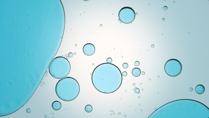 Blue oil drops floating in transparent fluid against pale blue background | Background for body care gel commercial shot