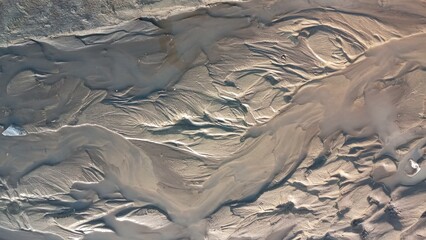 Dirty wet sand, grunge horizontal shabby background close-up. Blurry image of sand pattern....