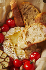 Camembert cheese baked with cherry tomatoes and baguette
