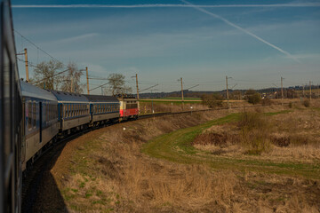 Fast electric train with coaches from Brno to Plzen in spring morning