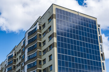 Obraz premium solar panels on the wall of a multi-storey building. Renewable solar energy.