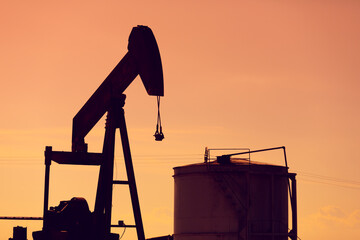 Backlit view of an oil well. oil extraction machine