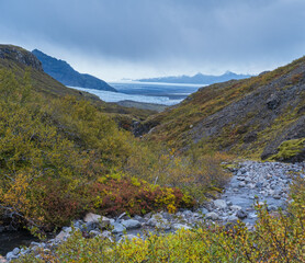 Beautiful autumn view from Mulagljufur Canyon to Fjallsarlon glacier with Breidarlon ice lagoon, Iceland. Not far from Ring Road and at the south end of Vatnajokull icecap and Oraefajokull volcano.