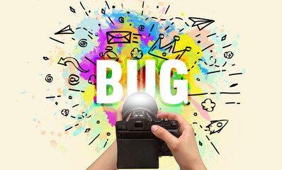 Close-up of a hand holding digital camera with abstract drawing