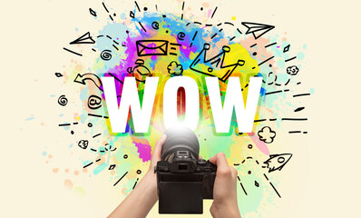 Close-up of a hand holding digital camera with abstract drawing