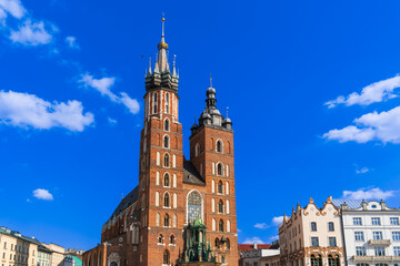 Basilica of Holy Mary on the main market square of krakow sunny day under a blue sky with white clouds