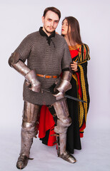 Obraz premium Knight in armor with a sword and a young woman in a medieval black dress. Love story. Married couple. Fantasy illustration for a book novel.