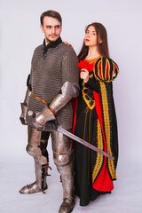 Obraz premium Knight in armor with a sword and a young woman in a medieval black dress. Love story. Married couple. Fantasy illustration for a book novel.