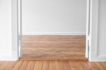 paruet floor in empty apartment room with open double wing door ,