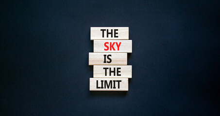 Sky is limit symbol. Concept words The sky is the limit on wooden blocks. Beautiful black table black background. Business motivational stress spice of life concept. Copy space.