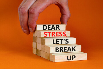 Stress break up symbol. Concept words Dear stress let is break up on wooden blocks. Businessman hand. Beautiful orange table and background. Business motivational stress break up concept. Copy space.