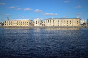Fototapeta premium Big old building on the river bank in the city