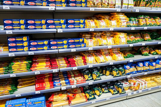 Various packaged pasta and macaroni on a shelf in a superstore