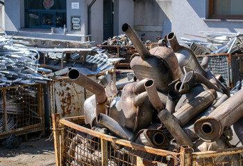 A pile of car mufflers at the junkyard
