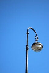 old street lamp against the sky in the city