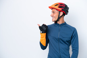Young cyclist caucasian man isolated on white background pointing to the side to present a product