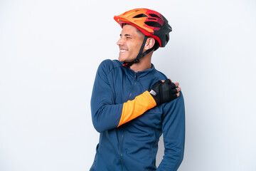 Young cyclist caucasian man isolated on white background suffering from pain in shoulder for having made an effort