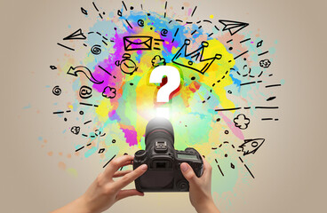 Close-up of a hand holding digital camera with abstract drawing concept