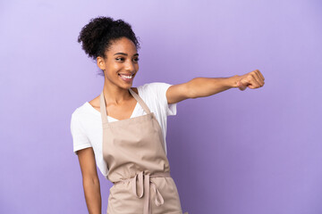 Restaurant waiter latin woman isolated on purple background giving a thumbs up gesture