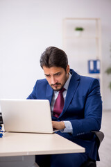 Young male employee working at workplace