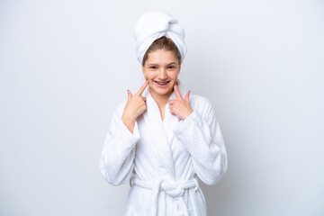 Teenager Russian girl in a bathrobe isolated on white background giving a thumbs up gesture